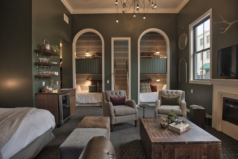 room with a bed and a table and a fireplace