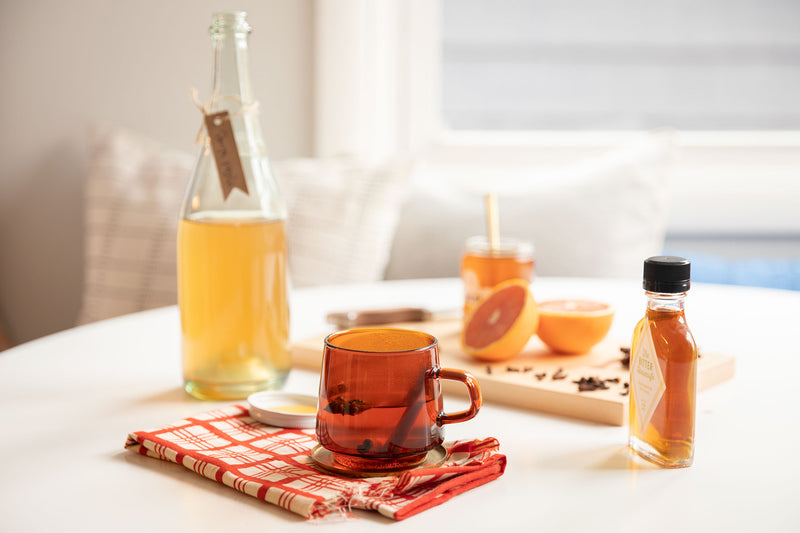 table with a drink and citrus on it
