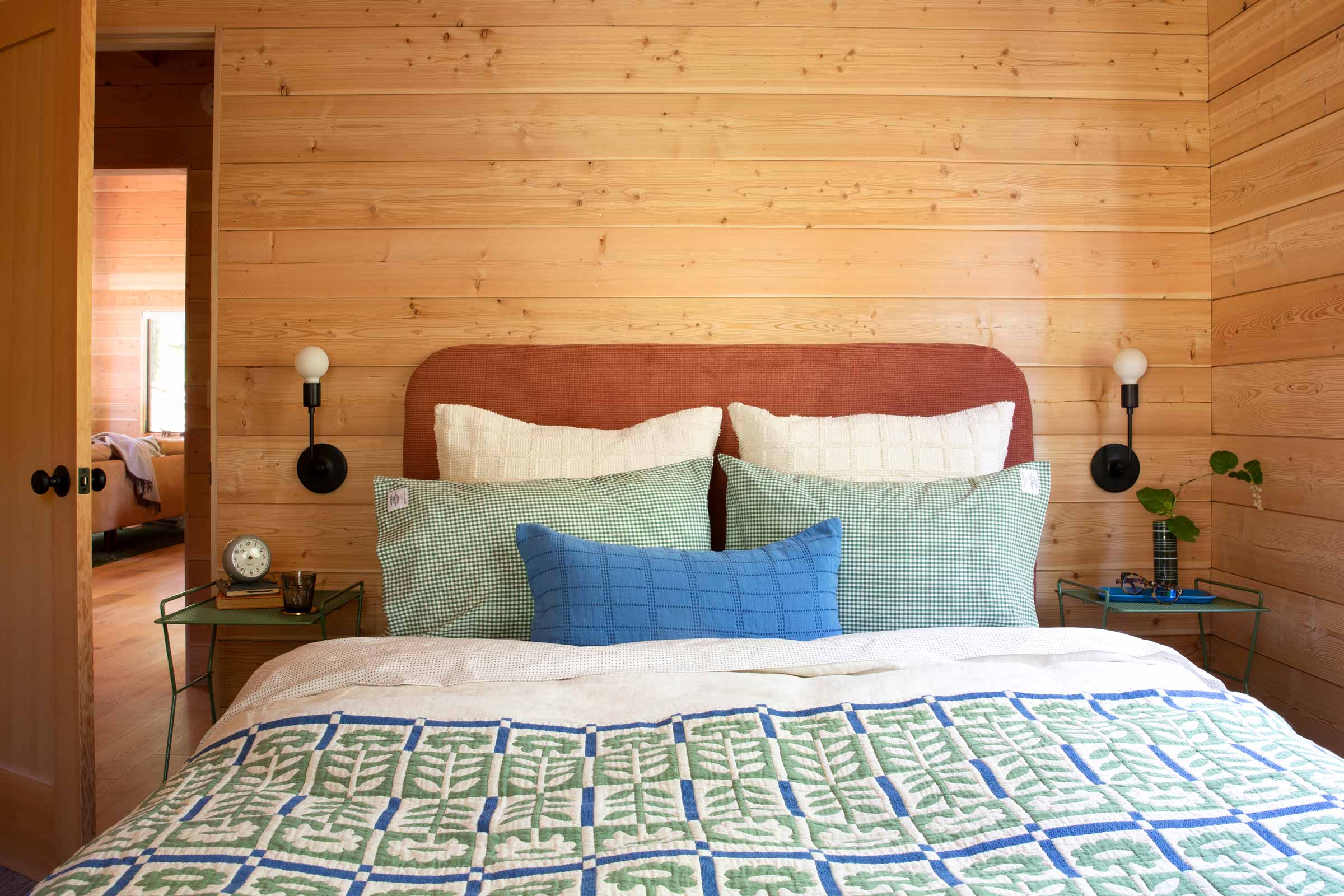 A cozy fall bed with a floral quilt.