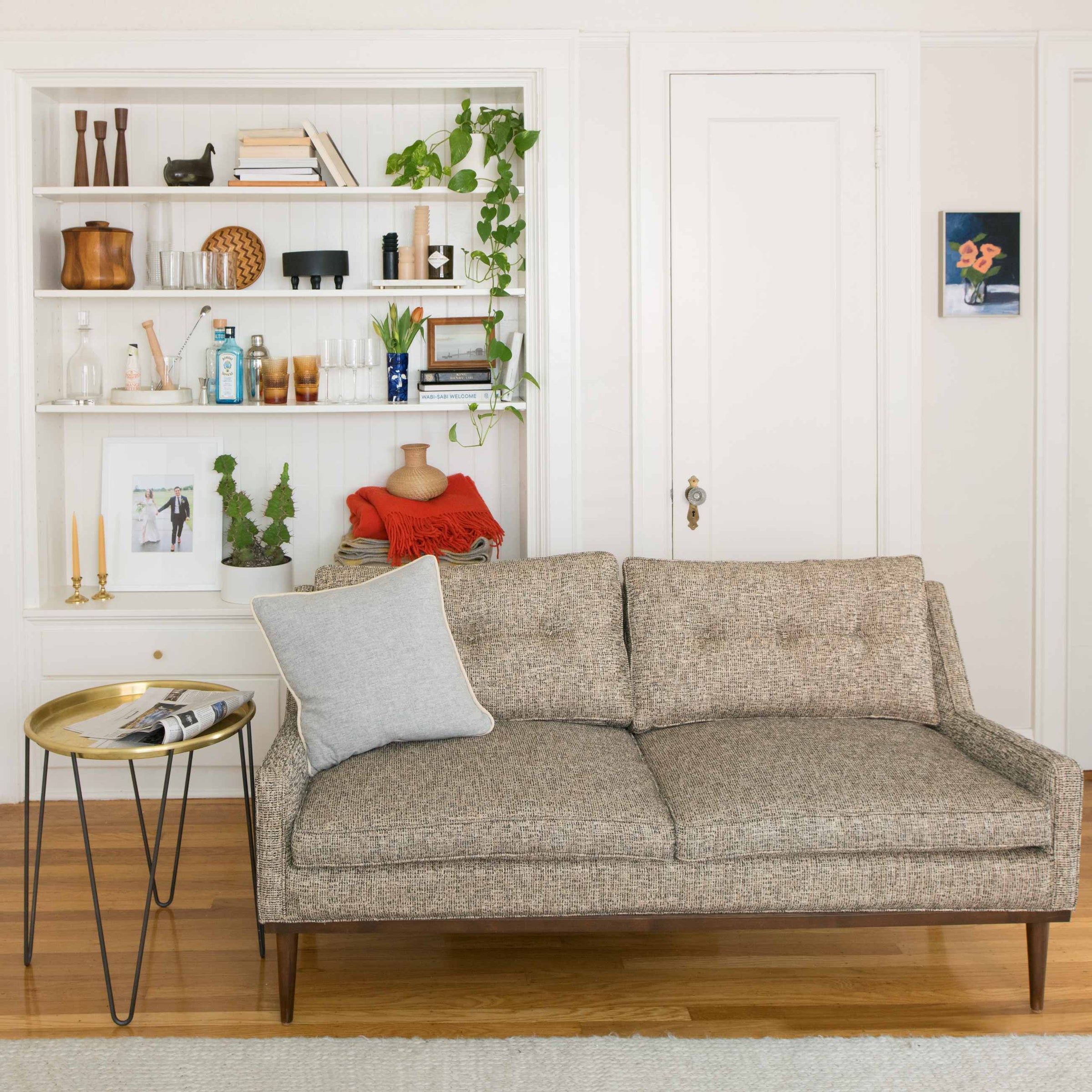 A cozy apartment with a built-in bookshelf.