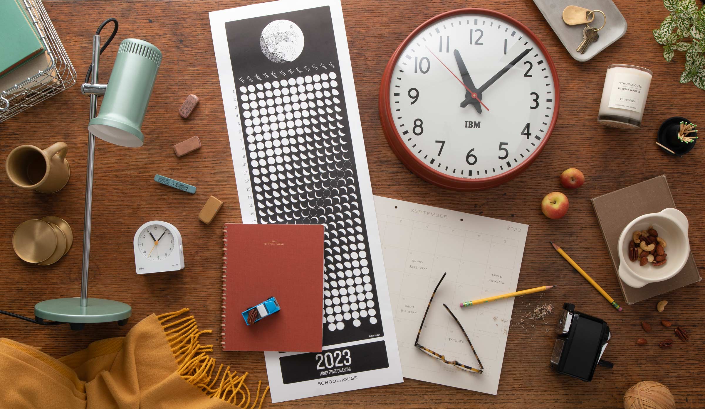 Office and school supplies laid out on a wooden table.