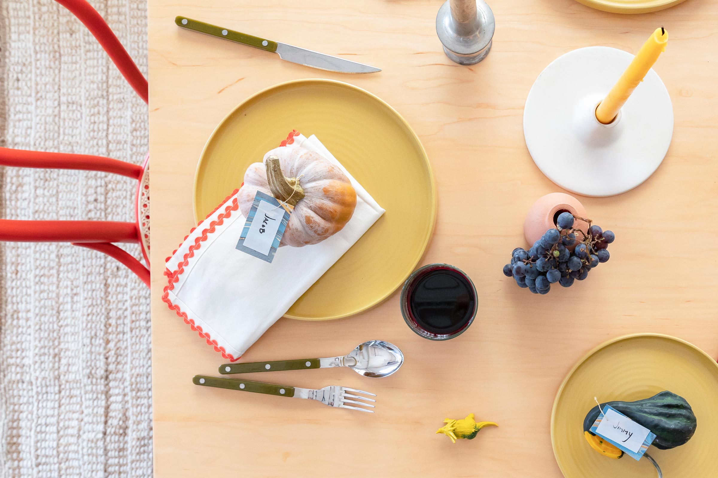 Petite pumpkin name card on a vibrant table setting.