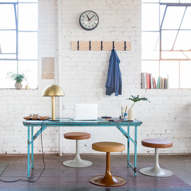 room with a blue desk and a gold lamp on it