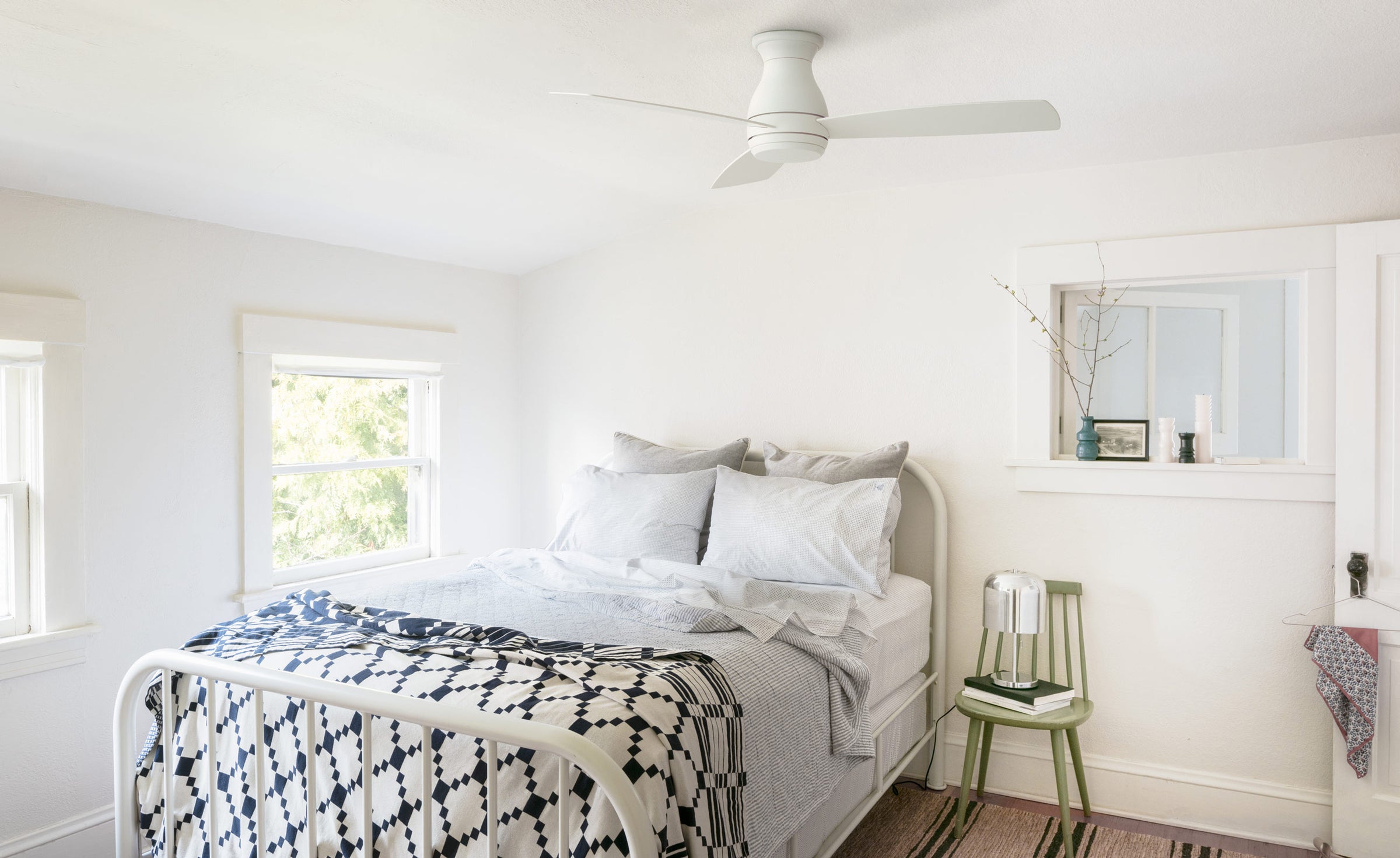 White Hugh 52" LED ceiling fan in a small bedroom above a twin bed.