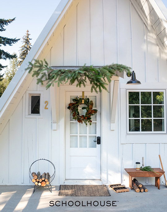 White A-frame house with wreath